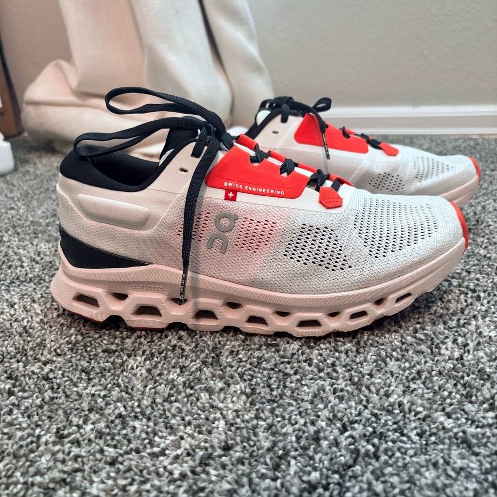 On CloudStratus Orange, White, and Black Athletic Shoes